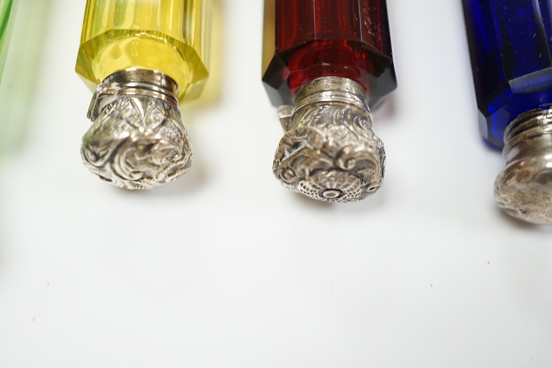 Six assorted late 19th/early 20th century white metal mounted coloured glass double ended scent bottles including pale green, 14.9cm and amethyst flash, 13.7cm (some a.f.)